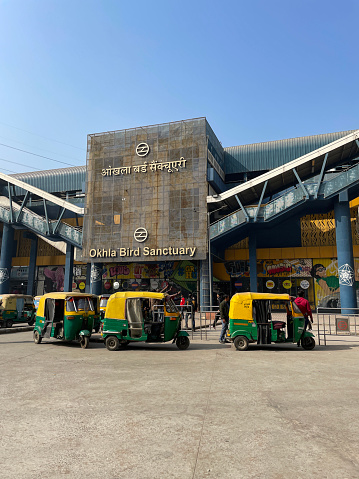 Sector 94 Metro Station, Noida, India - January 10, 2023: Stock photo showing auto rickshaws parked in a row awaiting passenger fares at Sector 94 Metro Station, a station on the Magenta Line of the Delhi Metro, New Delhi, India.