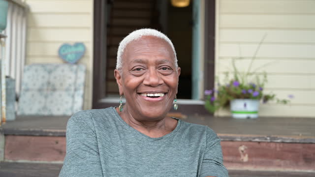 Headshot of senior Black woman on front steps