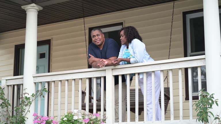 Mature African-American couple discussing problem on veranda