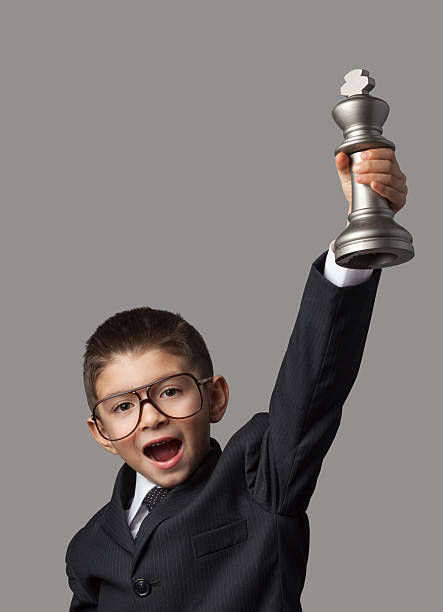istock Clever little boy lifting chess championship trophy 175947349