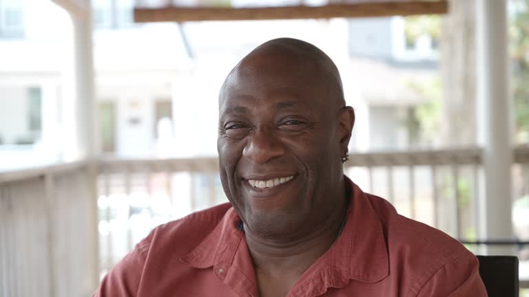 Headshot of mature African-American man outdoors, summertime