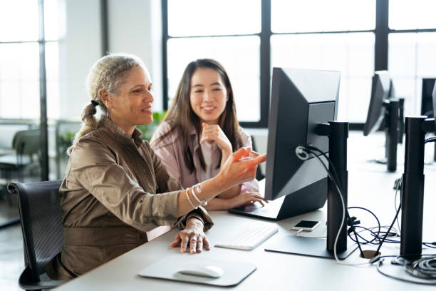 istock Businesswomen working together on laptop and desktop pc 1759476604