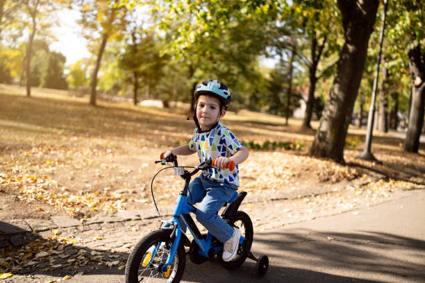 istock Boy riding a bicycle in a public park 1759476648