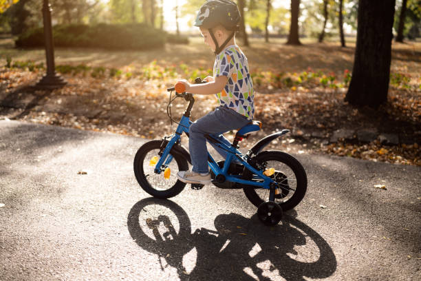 istock Boy riding a bicycle in a public park 1759477188