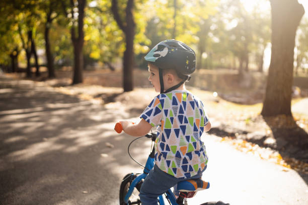 istock Boy riding a bicycle in a public park 1759477209