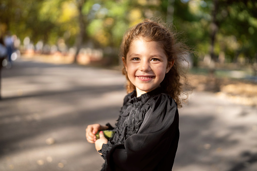 Portrait of a cute little girl in a public park.