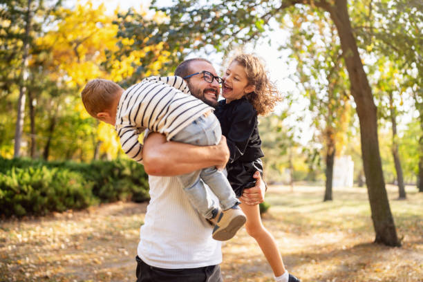 istock Happy father and two kids playing outside 1759478301