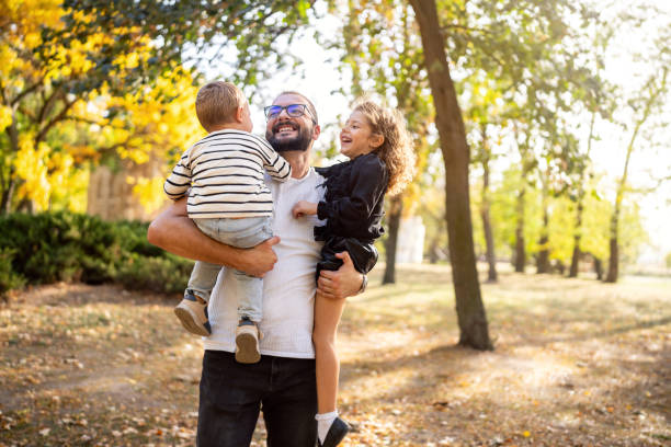 istock Happy father and two kids playing outside 1759478307