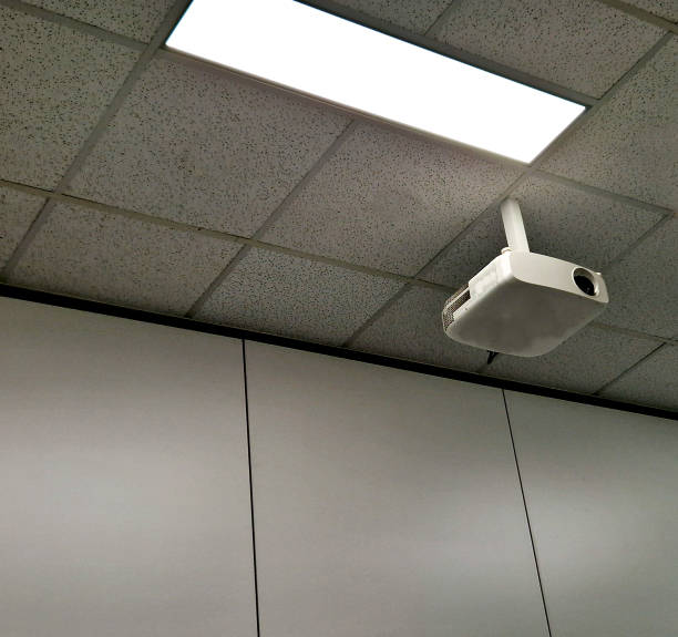 istock ceiling of the office with a double ceiling through which the cables for the lights run, and a video projector at the ceiling. bright design and hospital style. the lecturer has a great tool 1759483217