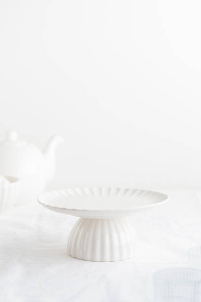 istock Empty tableware - white plate cakestand on white table as a background for a dessert 1759491209