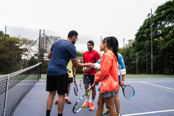 istock Coach greeting students arriving to tennis class 1759499523
