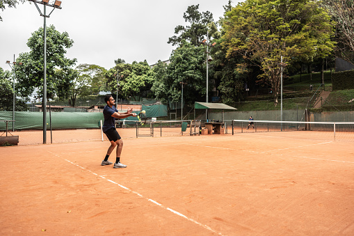 A racket and ball on tennis court with copy space. Outdoor sports and healthy lifestyle concept.