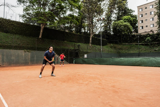 istock Young man playing doubles in a tennis court 1759501936