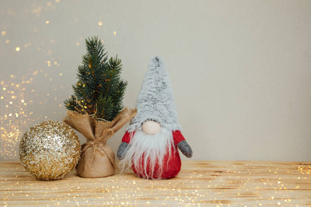 istock Background for greetings with empty space. Christmas tree and gnome on a light wooden background 1759503019