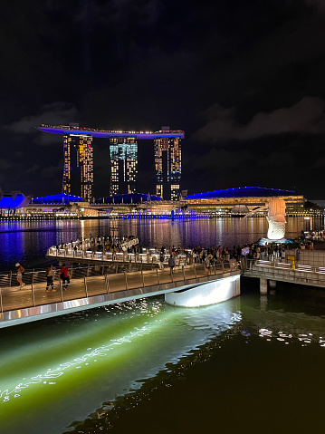 SINGAPORE, SINGAPORE - SEPTEMBER 28, 2013 : Night view of Marina Bay which surrounded by the Merlion fountain statue, Marina Bay Sands hotel, Singapore Flyer, Art Science Museum and Helix bridge, this place is famous tourist attractions in Singapore.