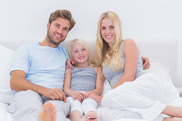 istock Couple using a laptop with their daughter 175950663