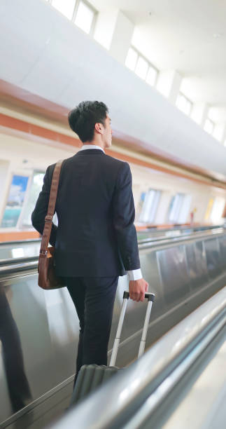 istock male business on airport escalator 1759534005