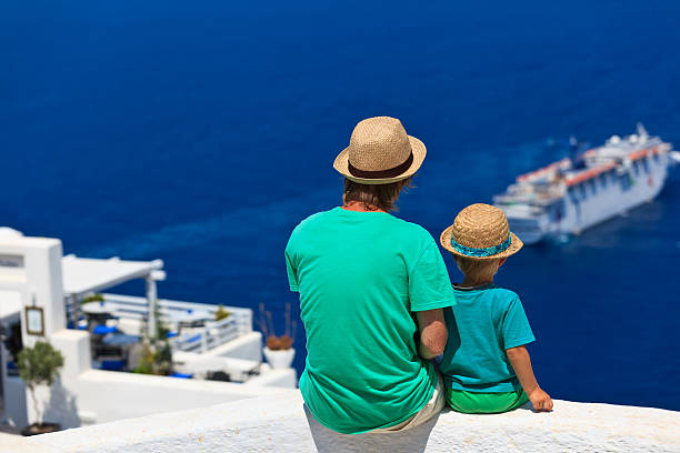 father and son looking at Santorini, Greece