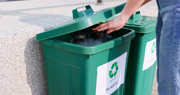istock woman trash in recycle bins 1759536684