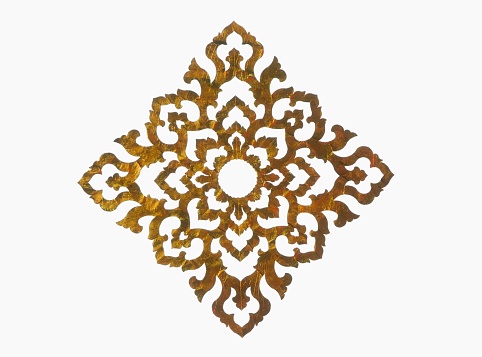 Gold paper cut into patterns. placed on a white background