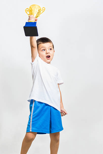 istock Little boy celebrates his golden trophy 175954259