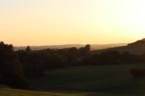 a sunset over meadows and forests in the Creuse in Limousin through mountains and valleys