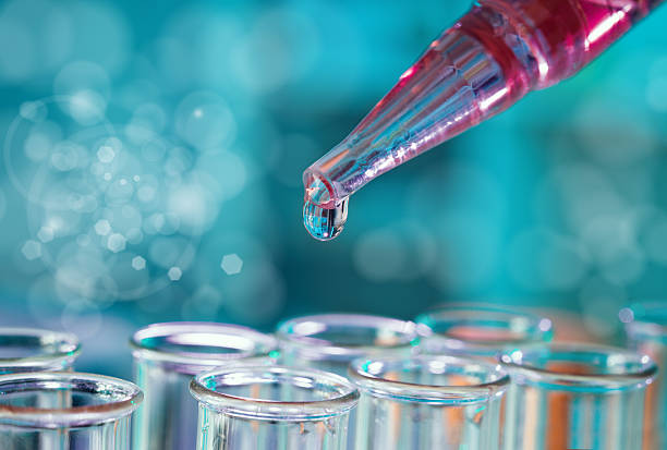 istock Pipette with a drop over glass tubes 175956841