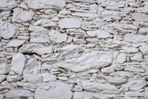 istock Old stone wall consisting of white stacked stones, background, pattern, texture, wallpaper. 1759572871