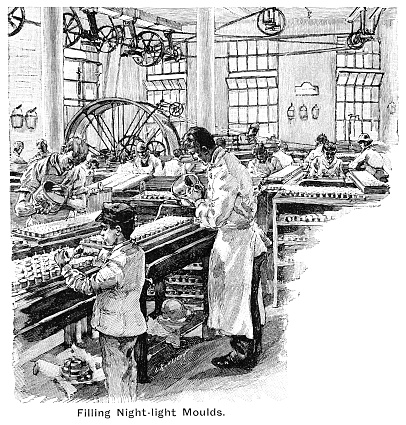 Workers filling night-light moulds, putting in and trimming wicks in a Victorian candle-making factory. One of the workers is a young boy. From “The Mothers’ Companion”, Vol IX, published in 1895 by S W Partridge & Co, London.