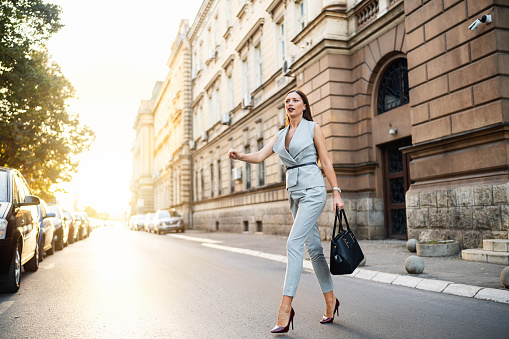 Businesswoman crossing the city street.