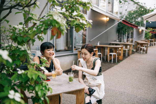 Two female friends having a refreshing drink at cafe