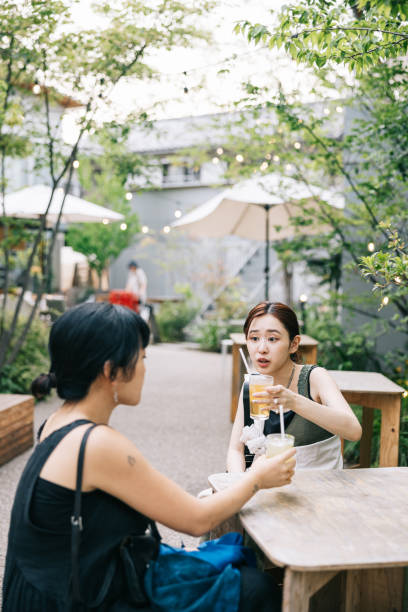 istock Two female friends having a refreshing drink at cafe 1759593292