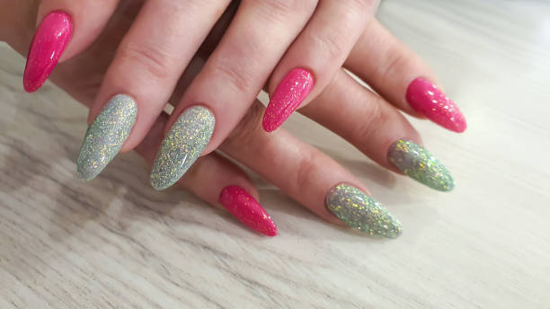 istock Acrylic nail extensions, manicure, nail correction, hands in the foreground. Reflective design. 1759601503