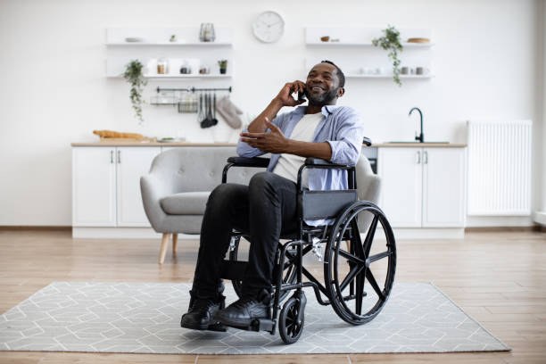 istock Adult in wheelchair talking on cell phone in studio flat 1759613383