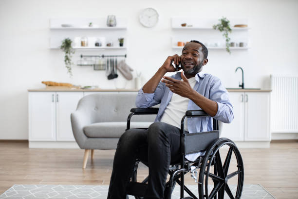 istock Male with mobility impairment speaking on mobile in kitchen 1759613899