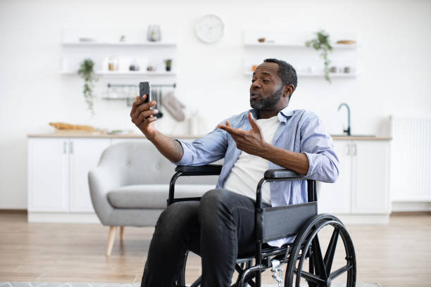istock Person with disability chatting via video call at home. 1759613907