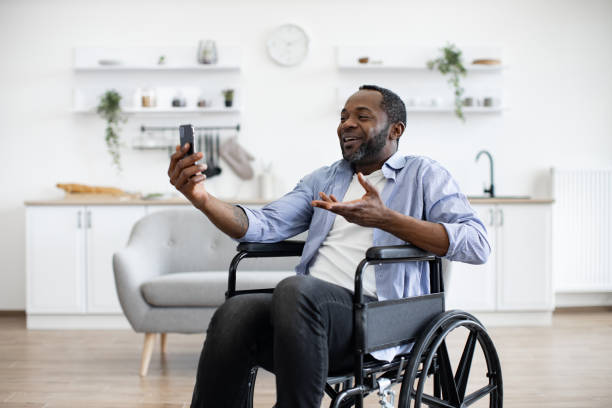 istock Person with disability chatting via video call at home. 1759613946