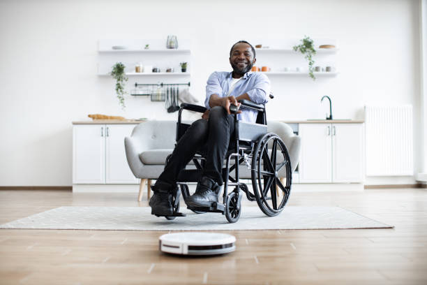istock Smart robotic vacuum operated by happy african man with mobility impairment. 1759615624