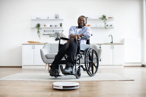 istock Smart robotic vacuum operated by happy african man with mobility impairment. 1759615626