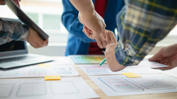 istock The designer team is designing the uxui system to make the uxui system work well on new phones and support system updates. Website development concept UI UX front end designer 1759616189