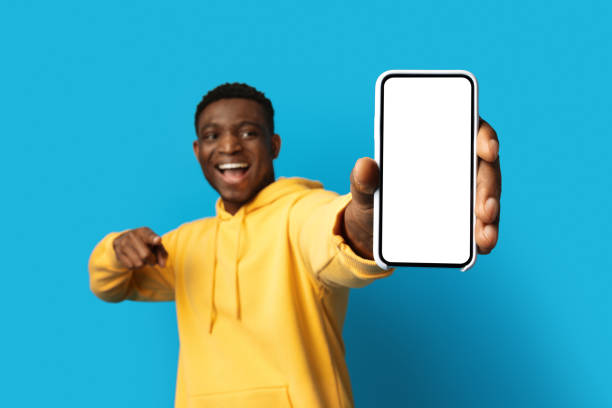istock Phone with white empty screen in african man hand 1759617243