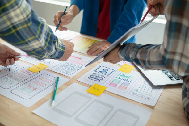 istock The designer team is designing the uxui system to make the uxui system work well on new phones and support system updates. Website development concept UI UX front end designer 1759618815