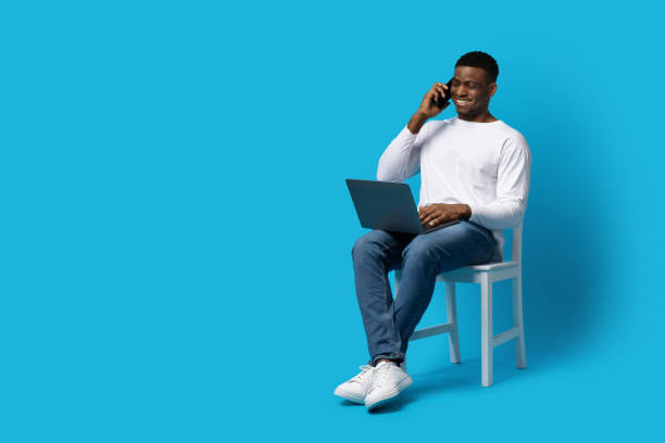 istock Young black guy businessman using phone and laptop 1759618823