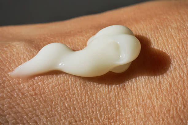 istock A smear of white moisturizer or sunscreen on a woman's hand. 1759623373