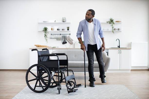 istock African man with disability using walking stick when raising from wheelchair 1759623541
