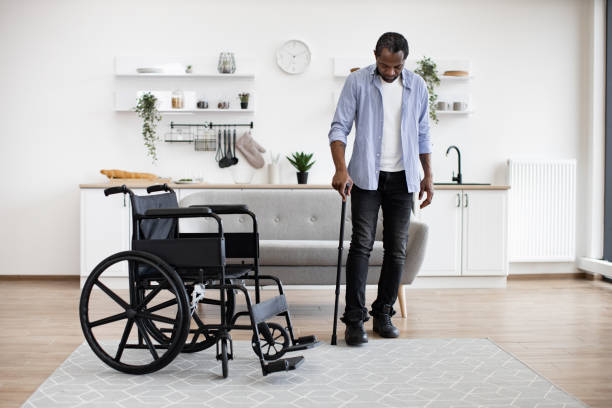 istock African man with disability using walking stick when raising from wheelchair 1759623909