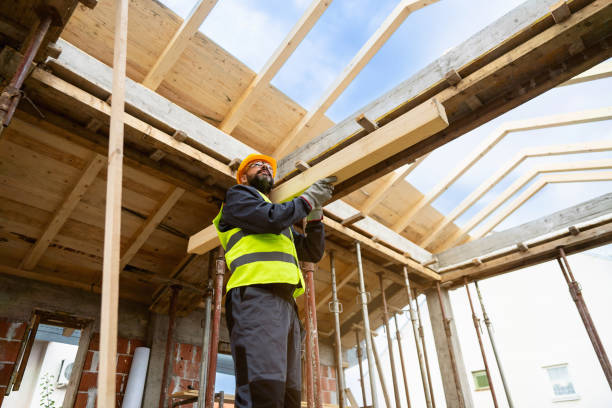 istock Caucasian male roofer, carrying an timber, while working on a construction site 1759630481