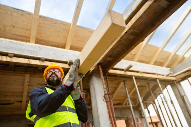 istock Caucasian male roofer, carrying an timber, while working on a construction site 1759631001