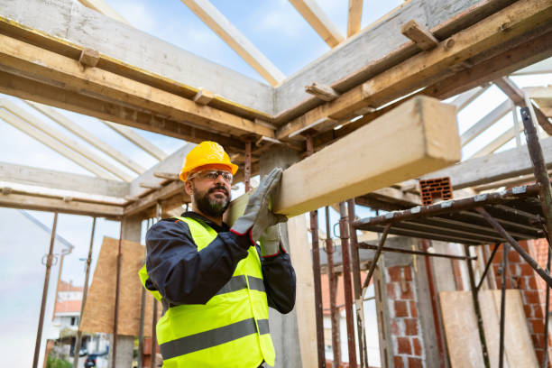 istock Caucasian male roofer, carrying an timber, while working on a construction site 1759631003