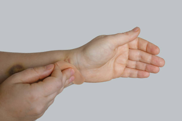 istock Woman hand with a band aid on white background 1759632682